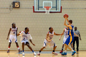 Four basketball players keeping others at bay using zone defence. Jeff Paton argues that software development is a game and Agile is a strategy for winning, not a process that guarantees success