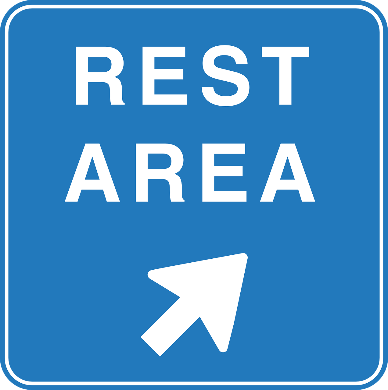 A sign saying 'REST AREA', with an arrow pointing up and to the right.