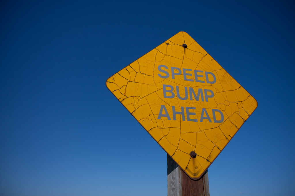 A "Speed Bump Ahead" sign, akin to Scott Shaw's warnings in his microservices talk