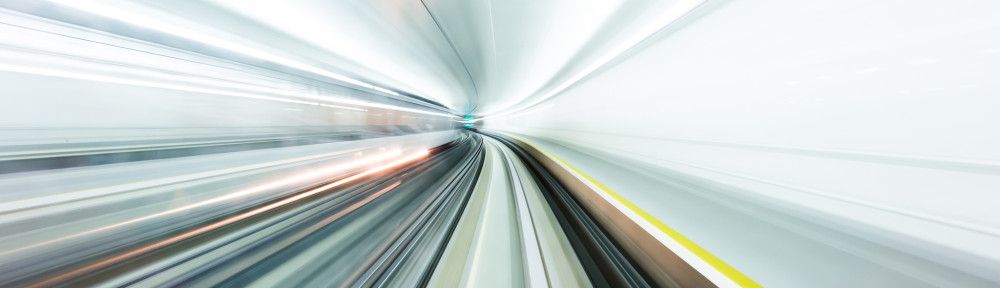 A bright photo taken using a slow exposure in a train tunnel, giving the impression of moving at warp speed, such as in the topic of Cameron Barrie's Mobile talk.