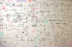 Whiteboard covered in a circuit diagram, which looks pretty similar to a typical software architecture