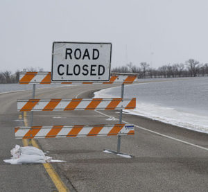 A "Road Closed" sign, an analogy for people to be wary of going down the path of distributed transactions in microservices