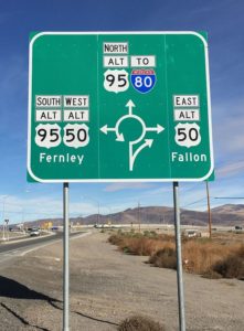 A road sign showing the alternate routes available off a roundabout