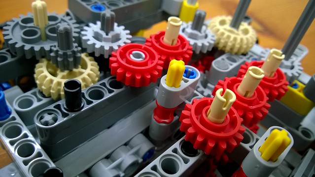 A large number of interacting LEGO cogs making one large machine, similar to a monolith from which you want to break out your first microservices